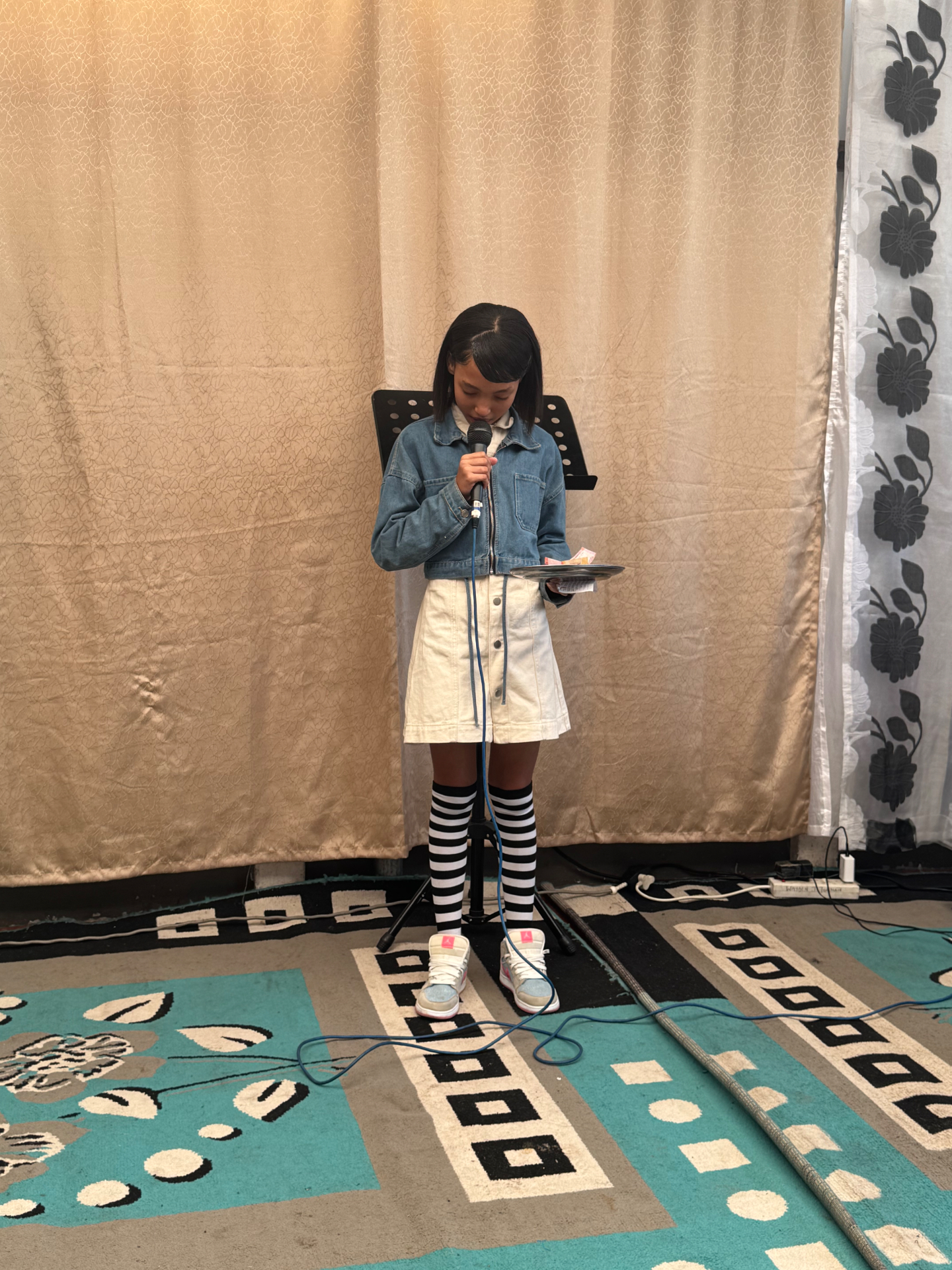Young girl leading with a microphone during Sunday School
