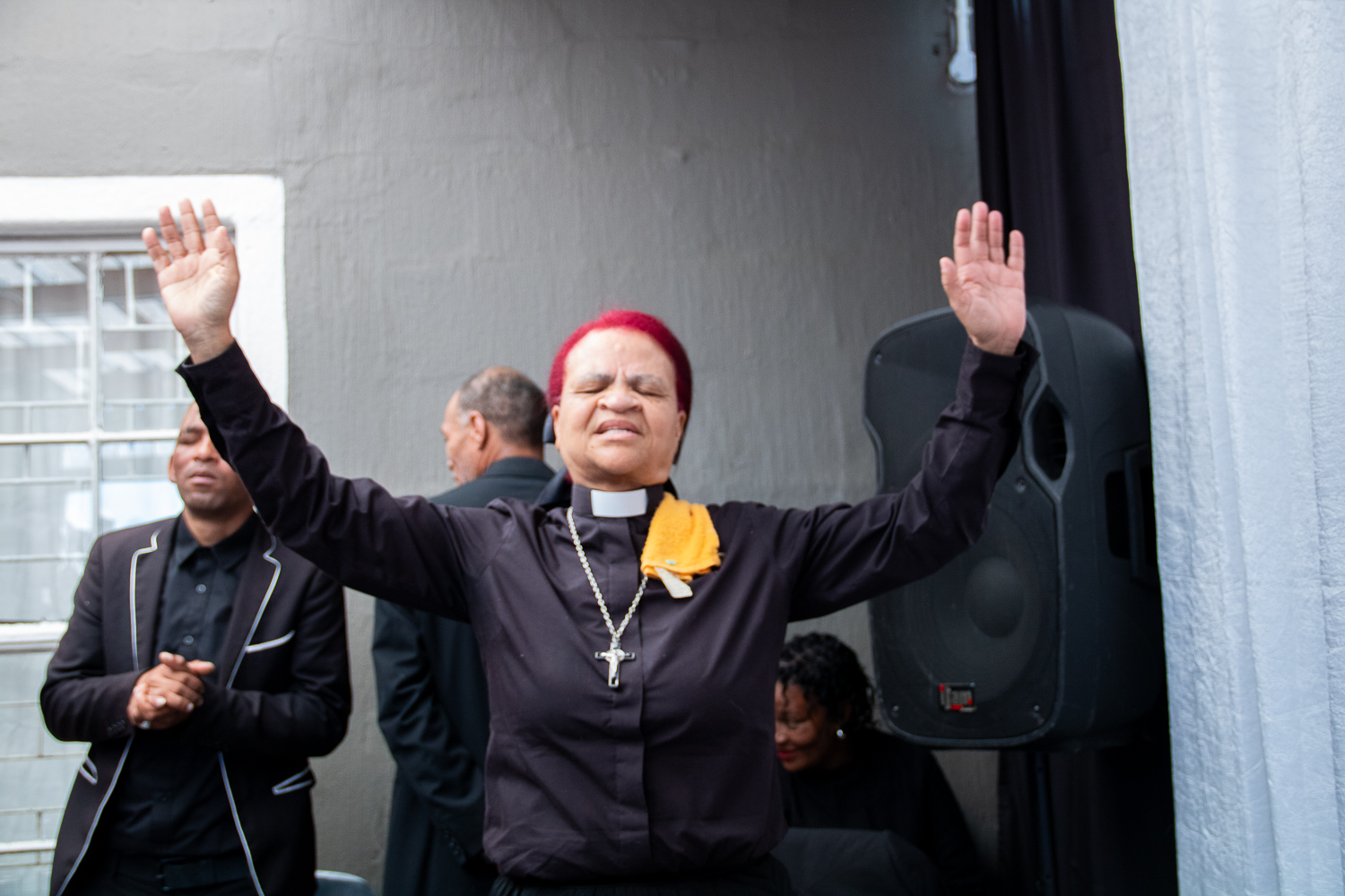 Congregation worshipping with hands lifted in praise