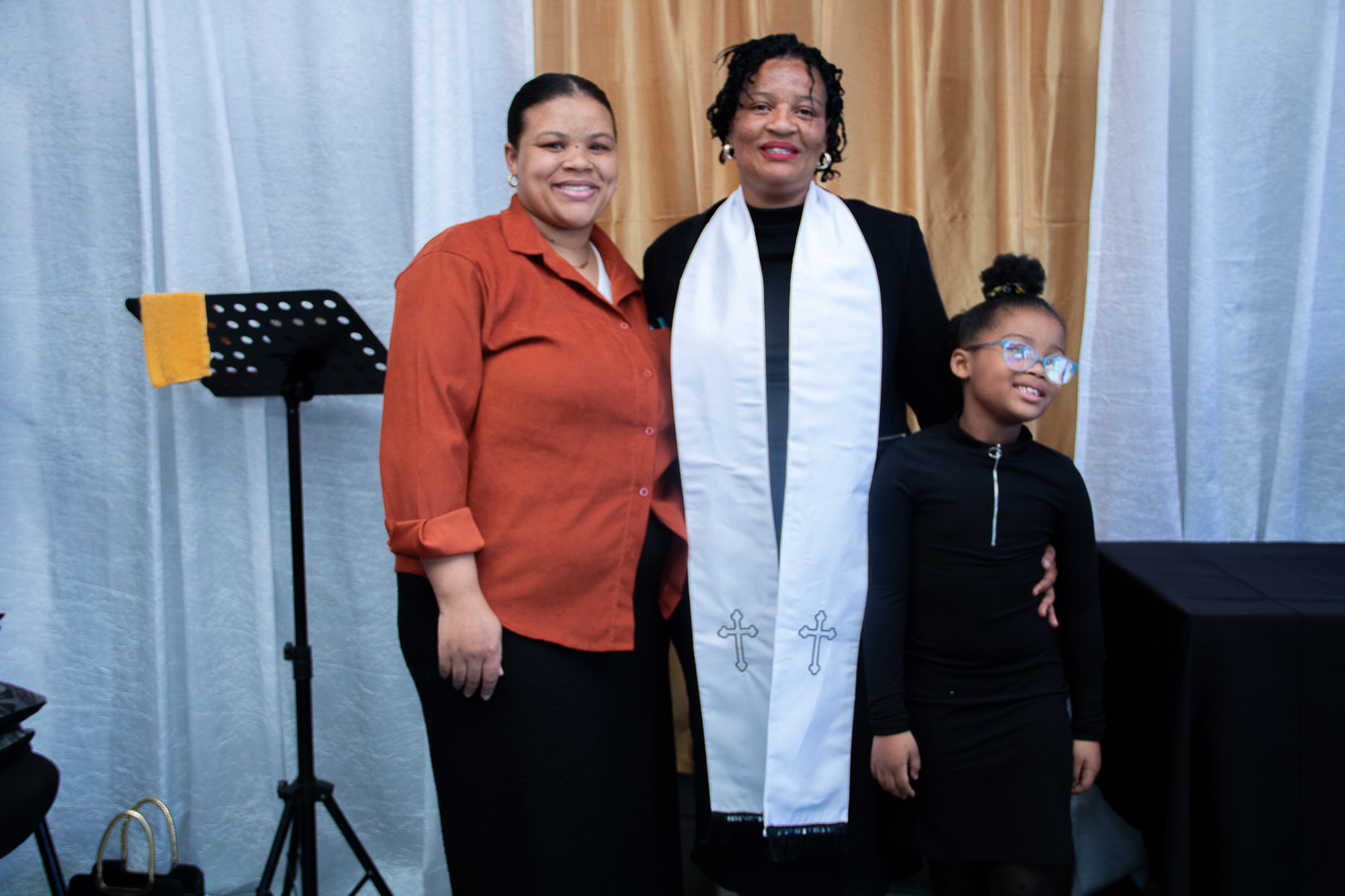 Church leader with a family after a special service