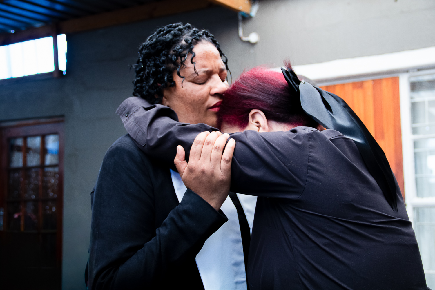 Two members embracing in fellowship after service